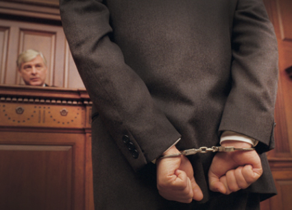 Image of man in handcuffs before a judge