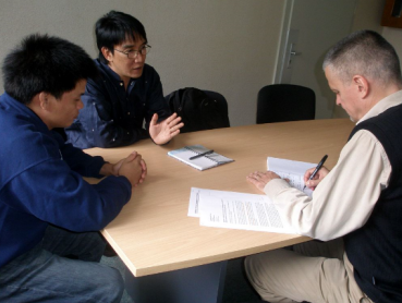 Image of man taking a statement from two other men